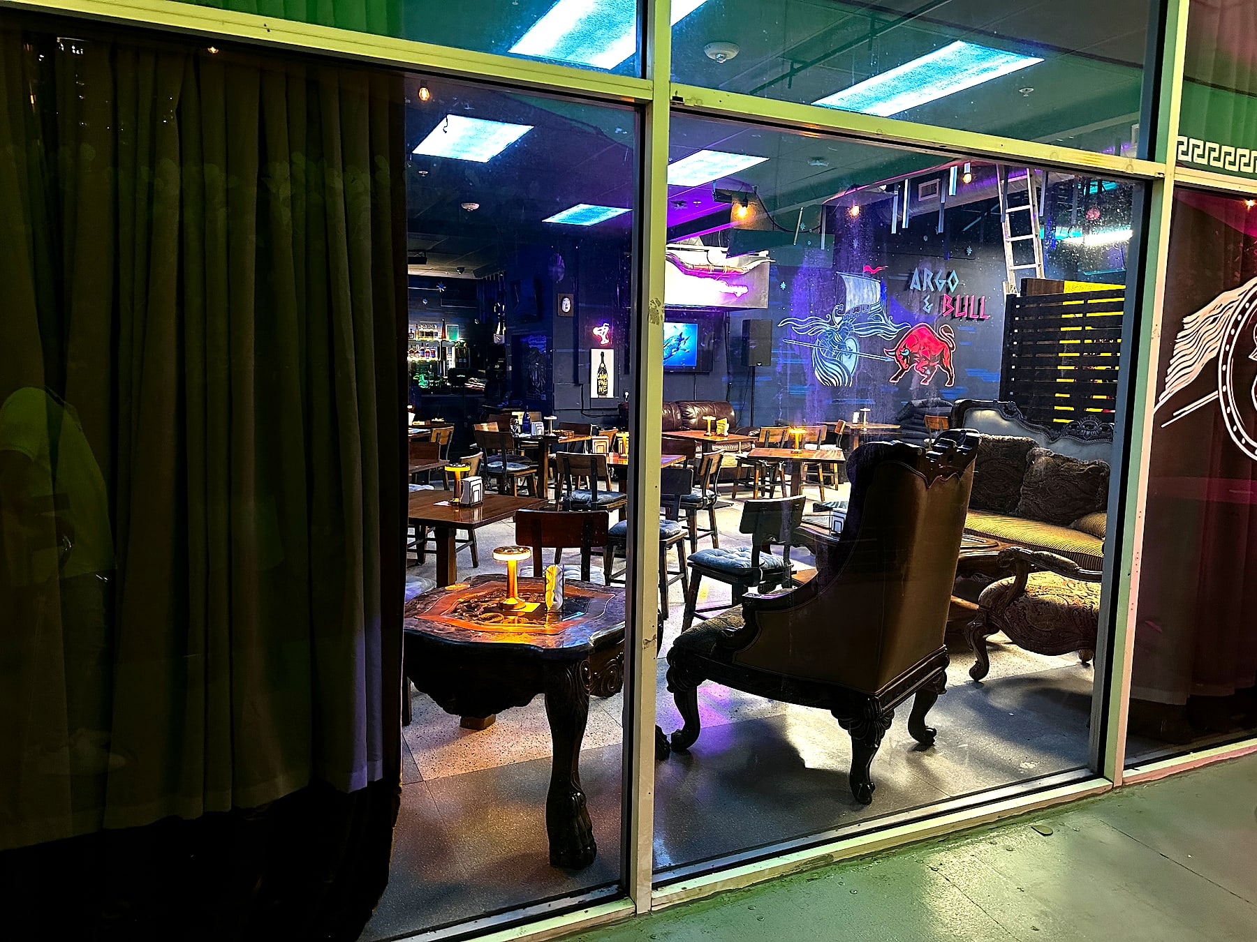 The Argo & Bull mural glowing over lounge seating, ready for a celebration